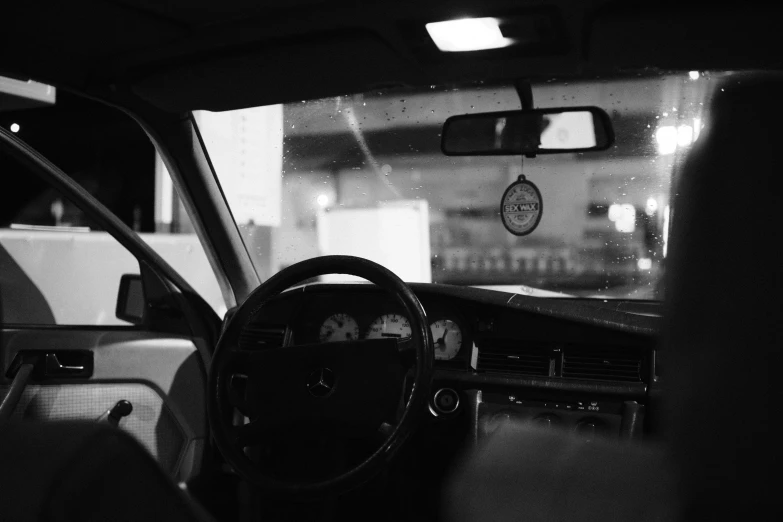 interior view of car, steering wheel and dashboard at night