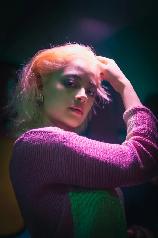 a woman with blonde hair is sitting in front of a camera