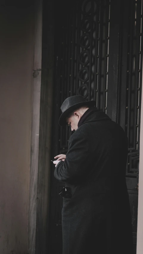 an elderly man texting on his cell phone