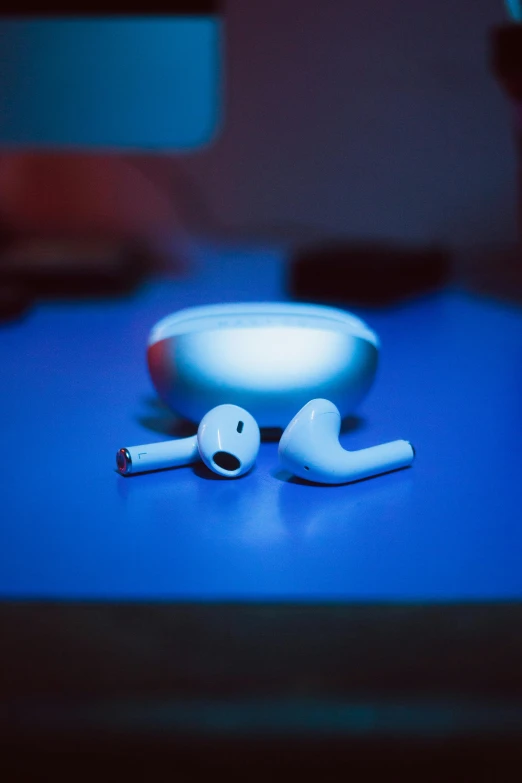 a pair of headsets sitting on top of a desk