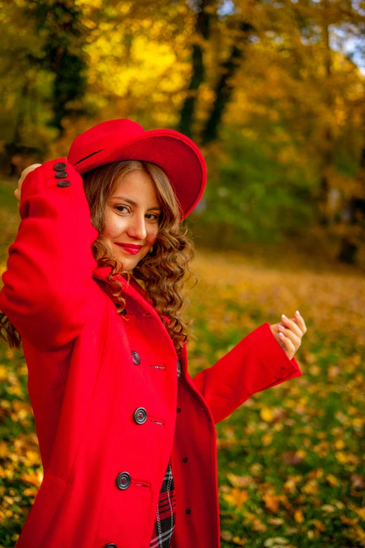 a woman in red coat posing for the camera