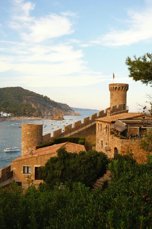 a castle overlooking the water is seen through the trees