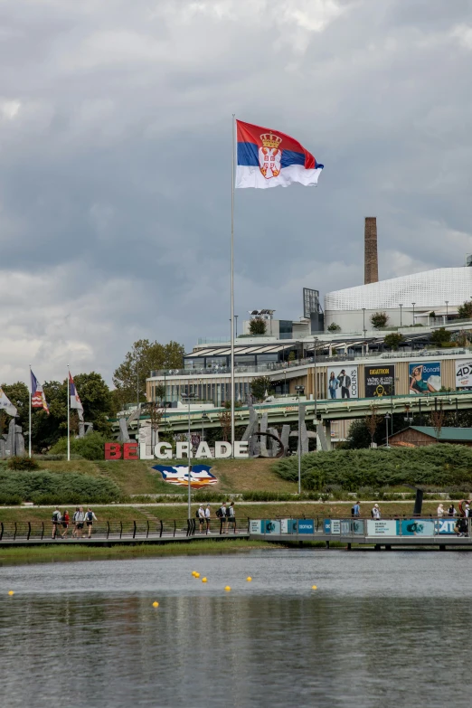 the large flag is flying over the river