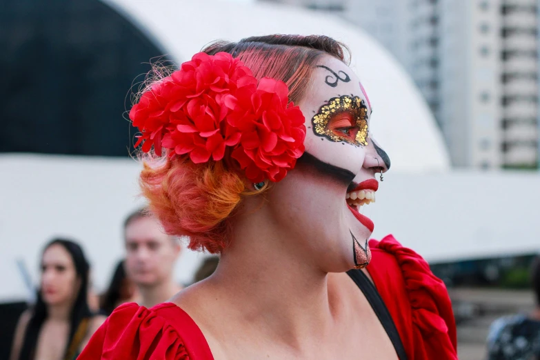 a person with makeup and a face paint and flower decoration