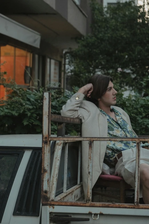 a man sitting on the back of a truck