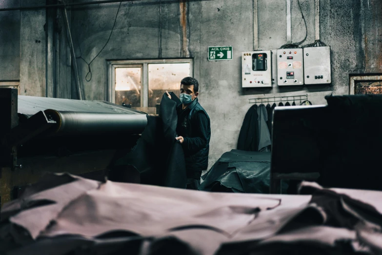 a man walking in a warehouse next to another person