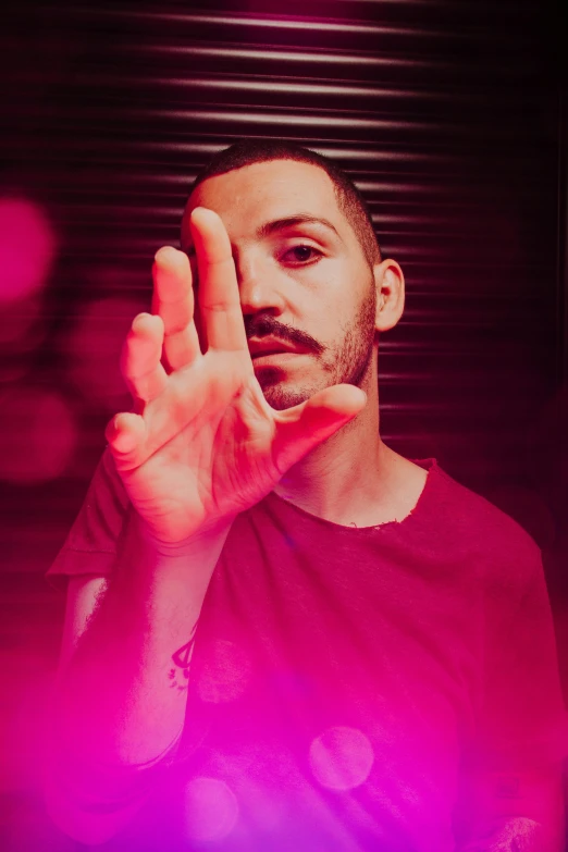 a man making the vulcan hand sign with his right hand