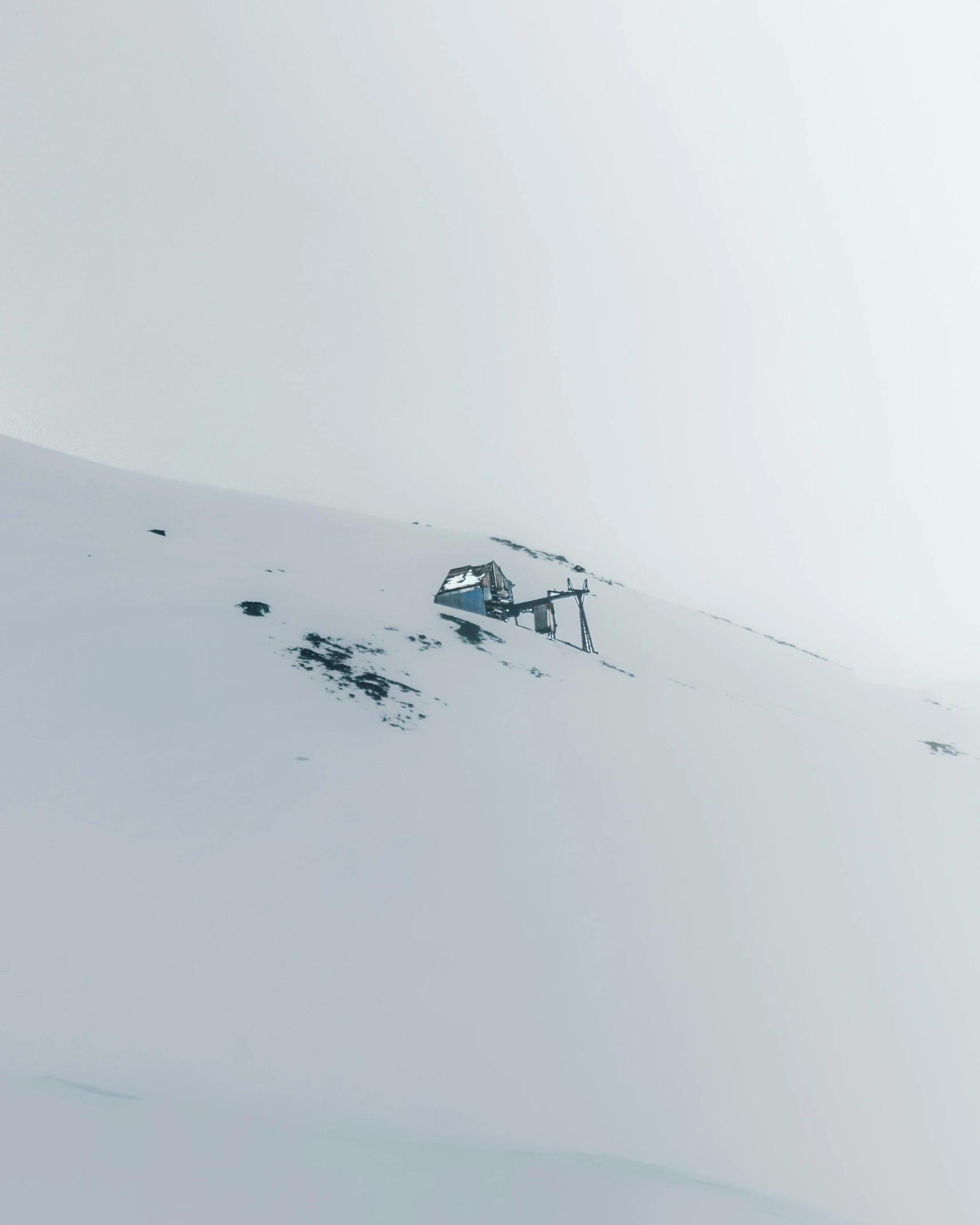 the skier is heading down a steep mountain with many small huts