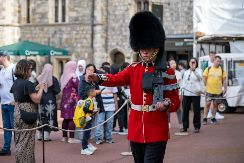 a person with a military uniform standing in front of a crowd