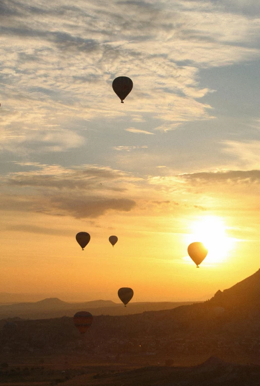 several  air balloons are flying in the sky