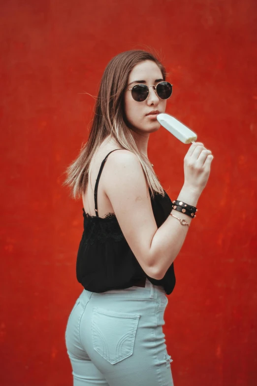 a woman is standing and holding her hands behind her chin and brush her teeth