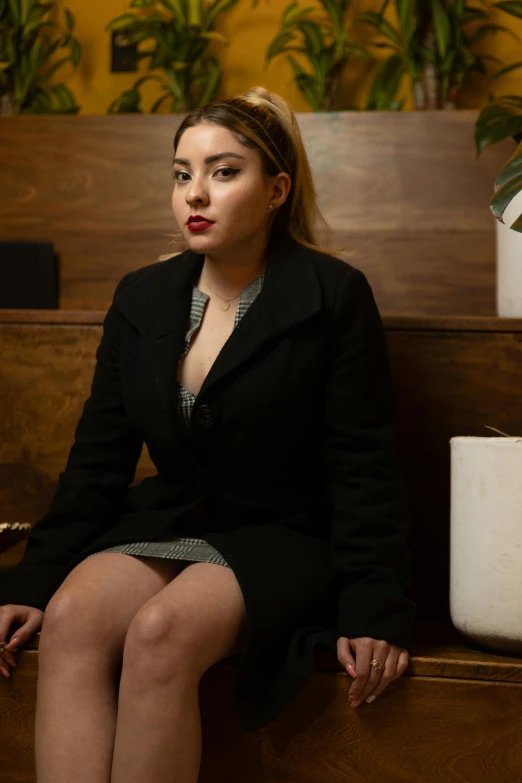 a woman with very short skirt and jacket sitting on a church bench