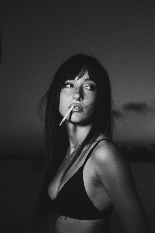 a woman smoking a cigarette in a black and white po