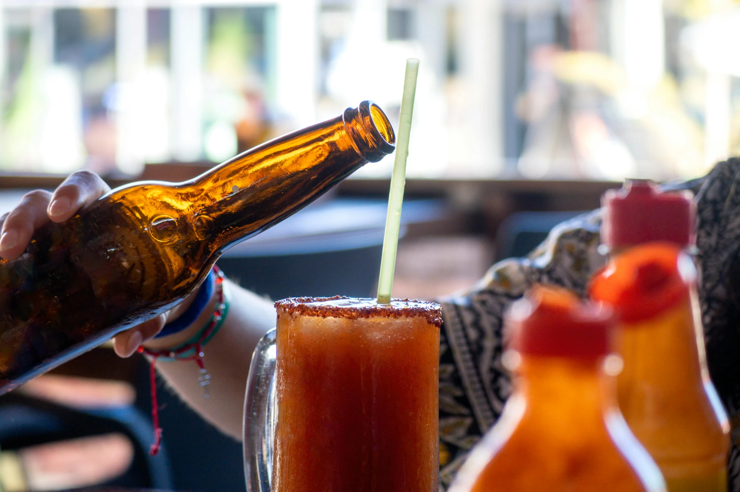 there is a woman holding a brown bottle and a beverage