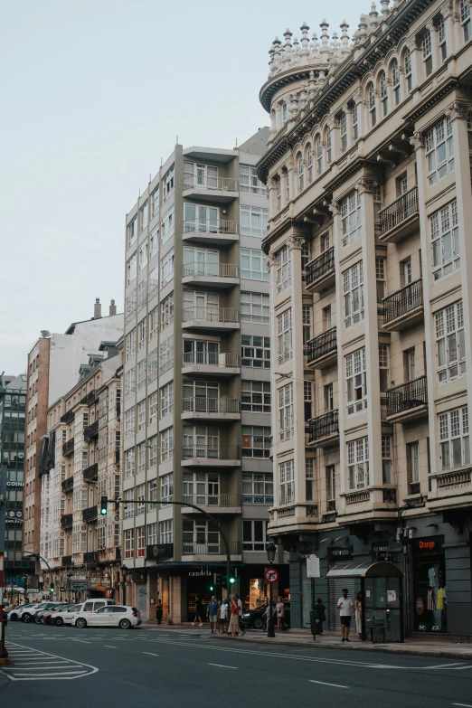 a couple of very tall buildings that have people walking