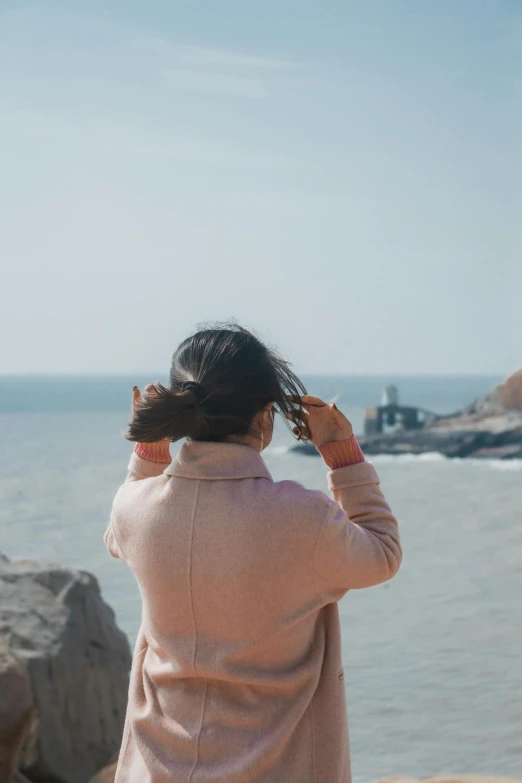 a woman standing on top of a cliff