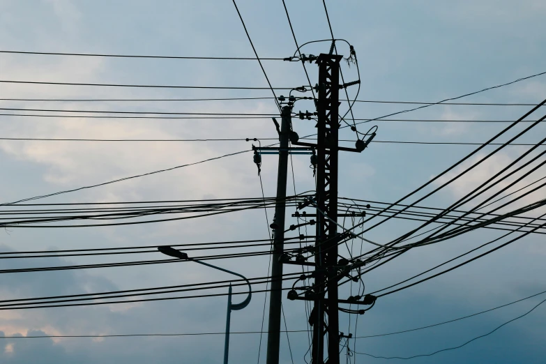 telephone wires against the blue sky during a storm