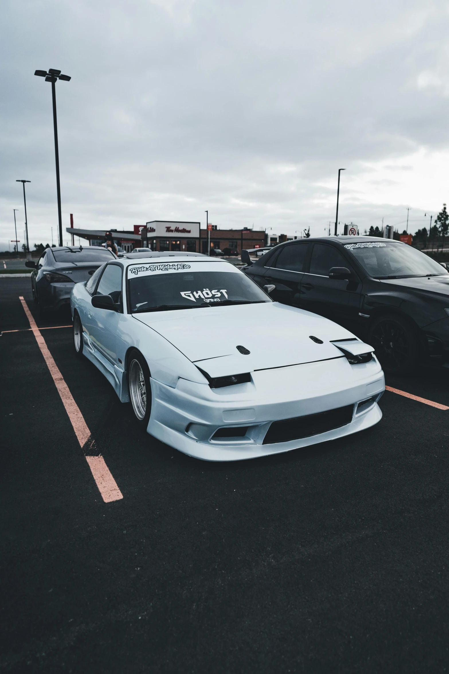 two sport car sitting in the parking lot