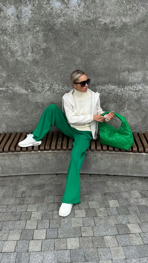 a person is on a bench wearing green pants