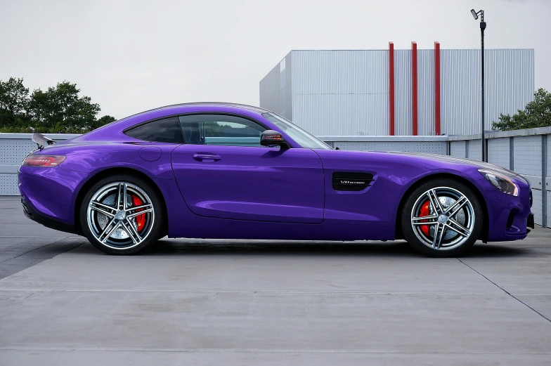 the sports car has been painted purple and is parked outside a building