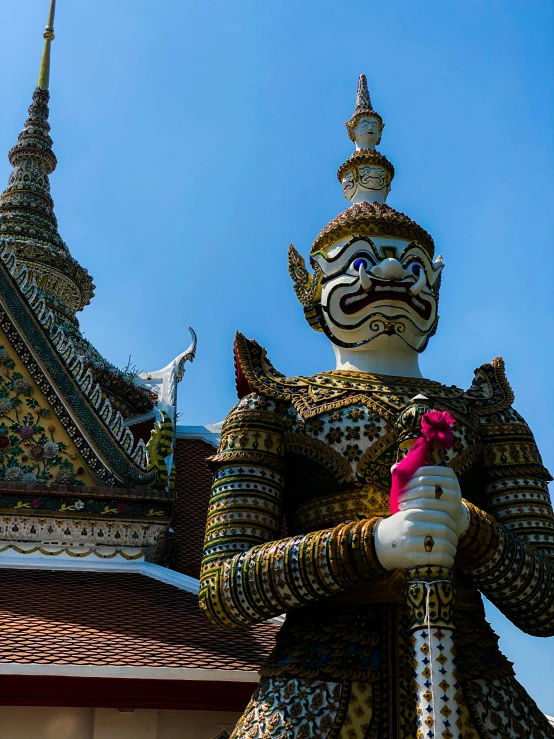 a statue of a man in golden and black outfits