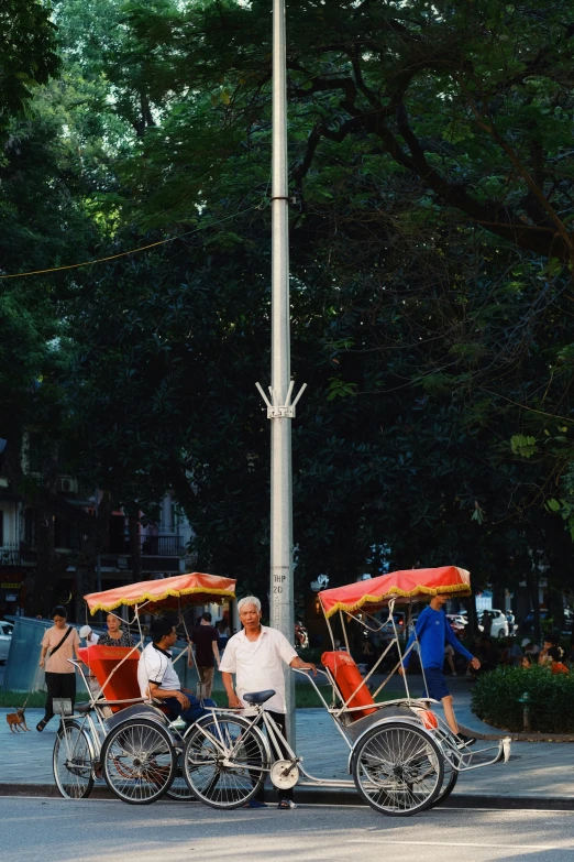 men standing next to bicycles and a flag pole