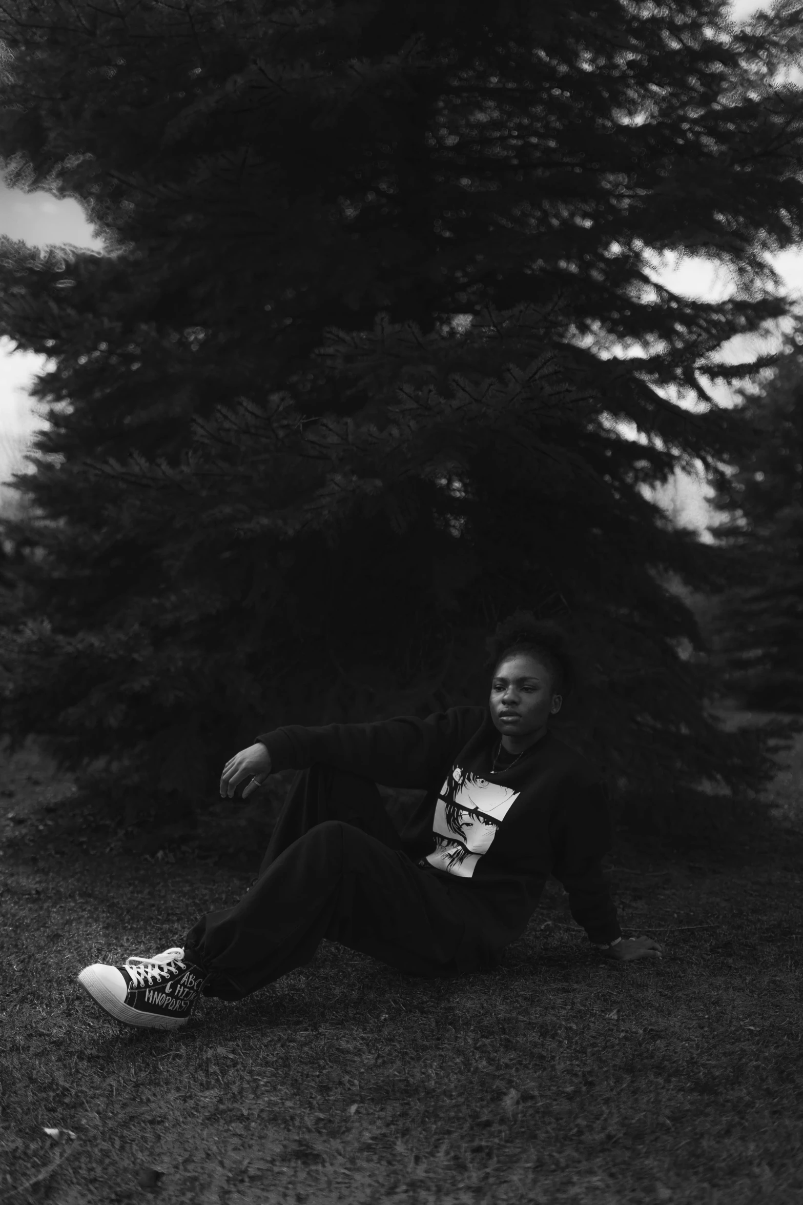 man laying in grass with his arms over knees