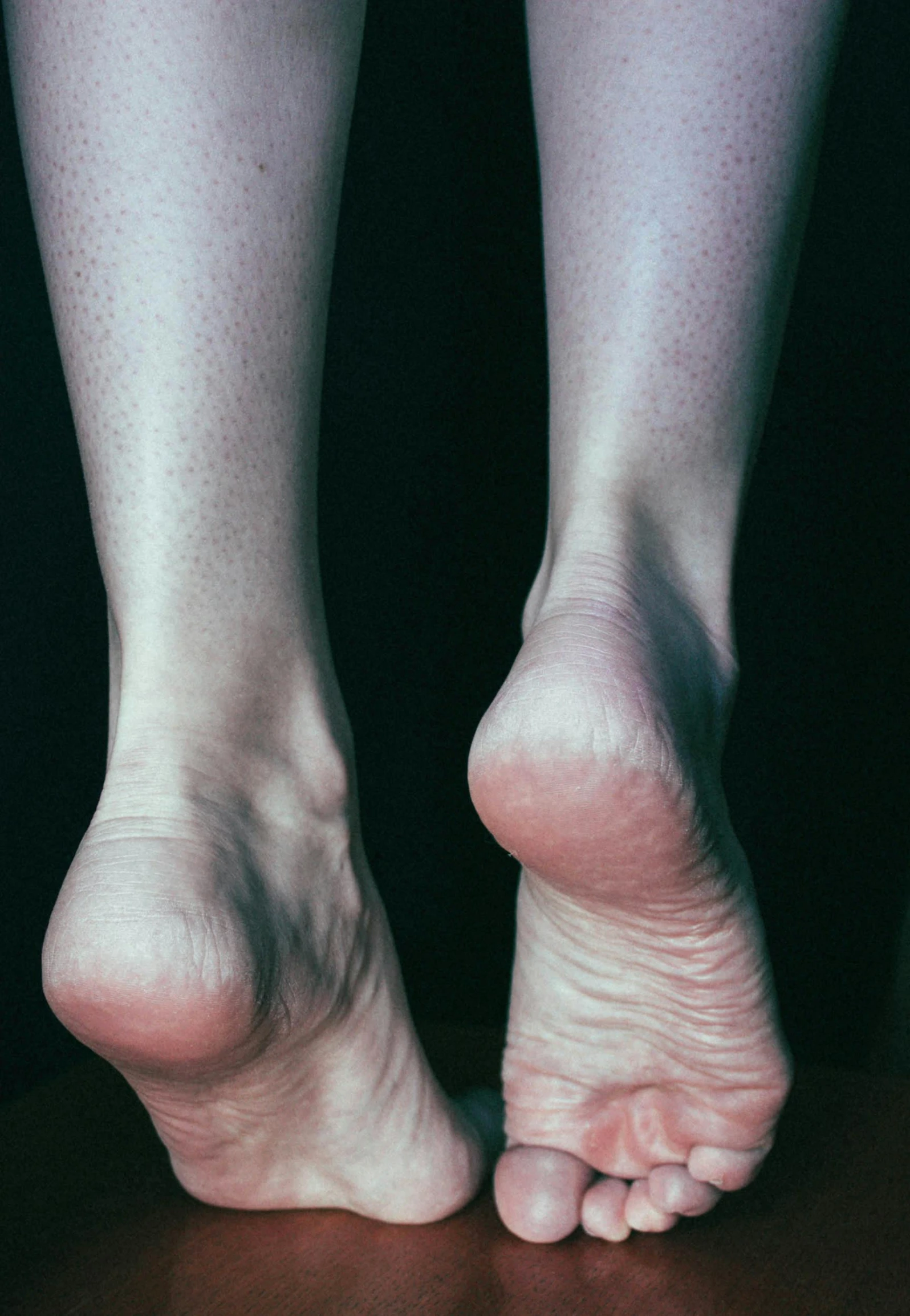 a woman's bare toes and feet in the dark