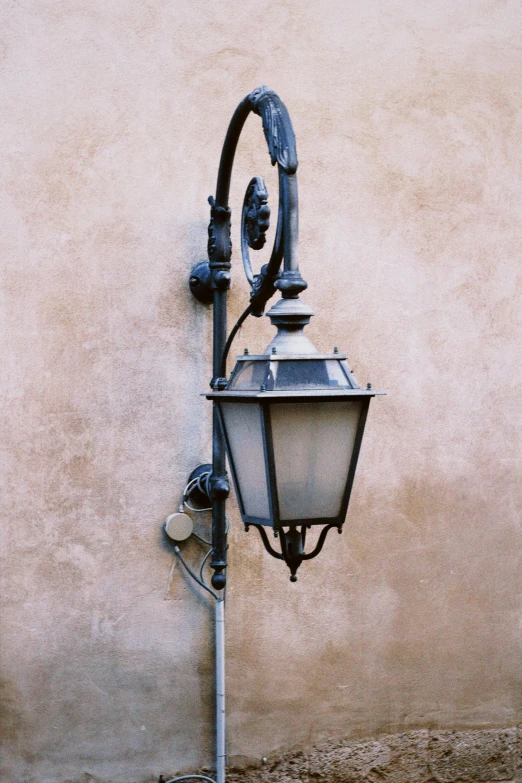 a metal street lamp near an old building