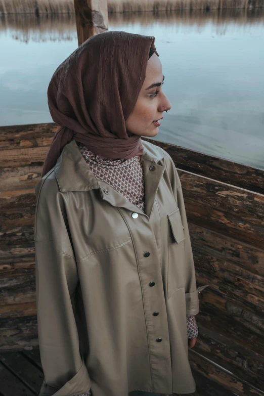 the woman is standing in front of the water