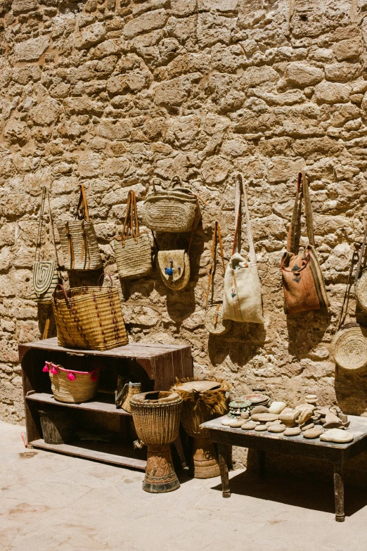 there are bags hanging on the wall near the bench