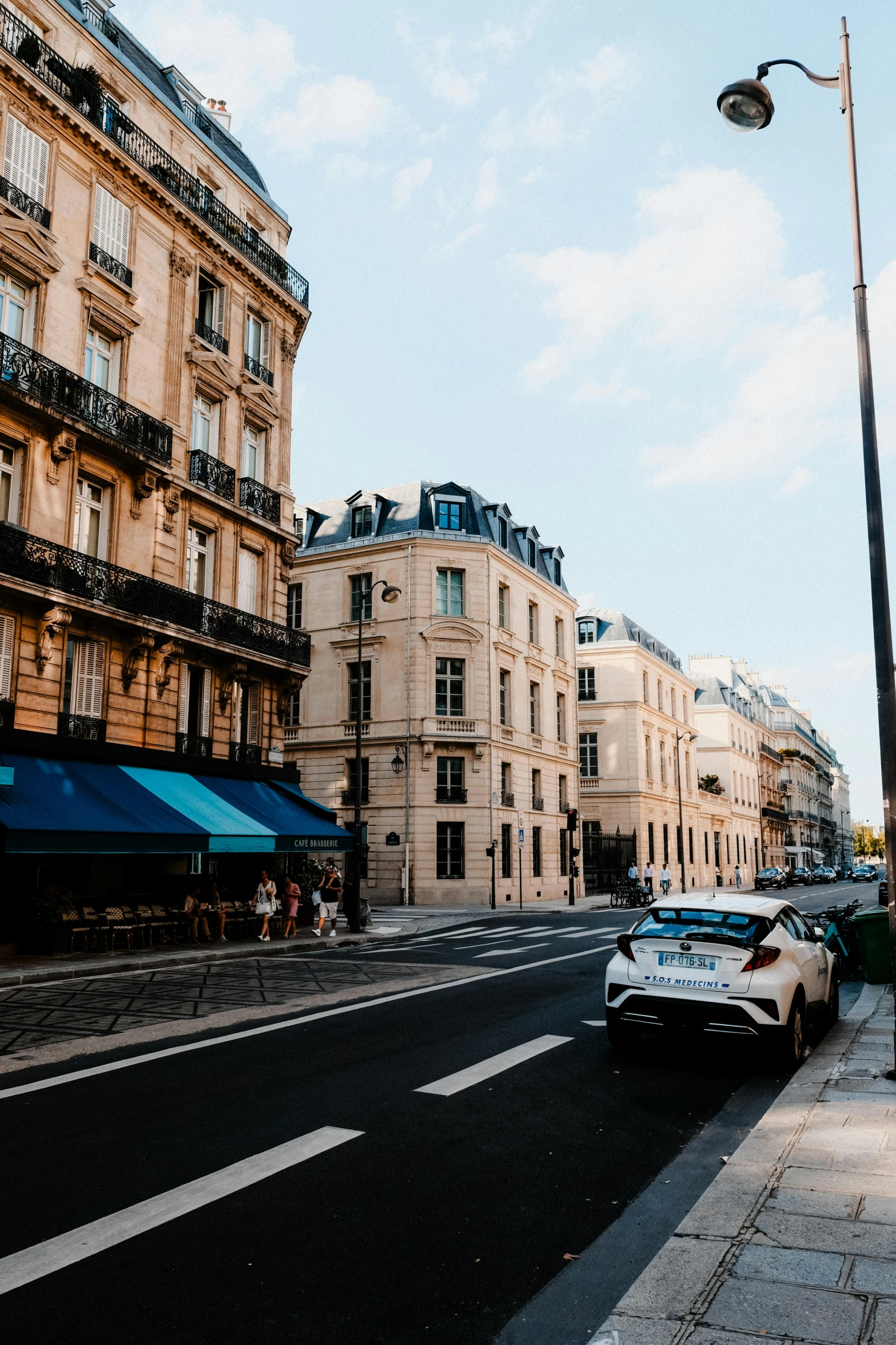 an old town street with cars parked on it