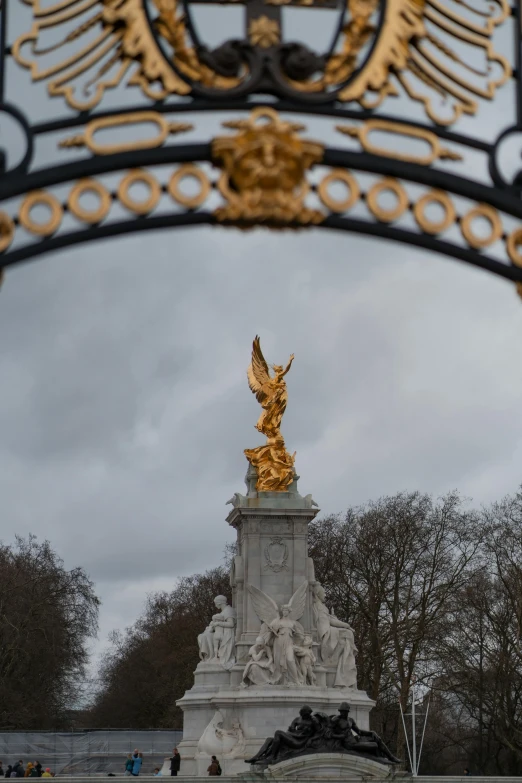 looking through the arch at a statue near an archway