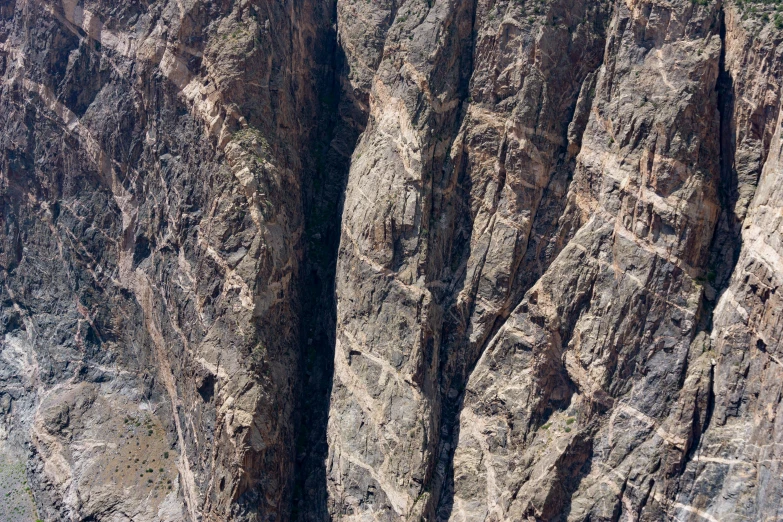 the landscape is rugged and barren by tall rocks