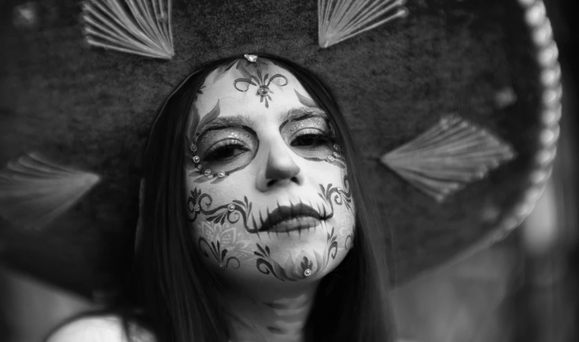 a woman with painted face paint and feathers on her head