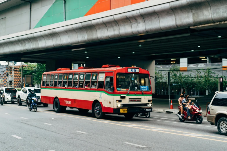 a red and white bus traveling down the street