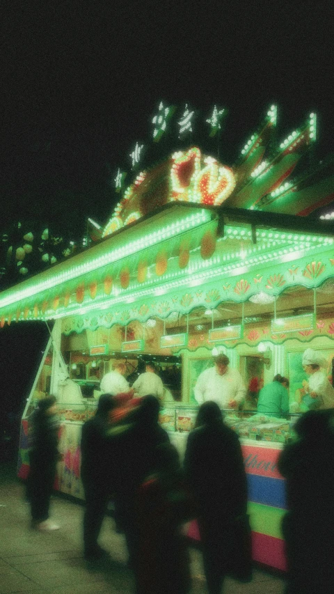 blurred pograph of people looking at a merry go round