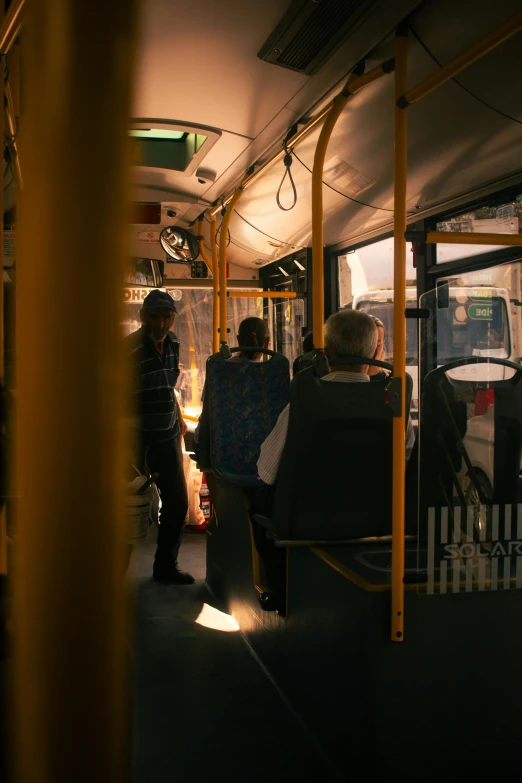 a train in the dark with people sitting on seats