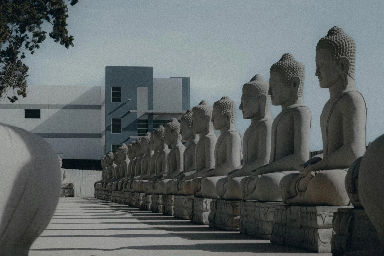 there are many statues lined up on the side of the street