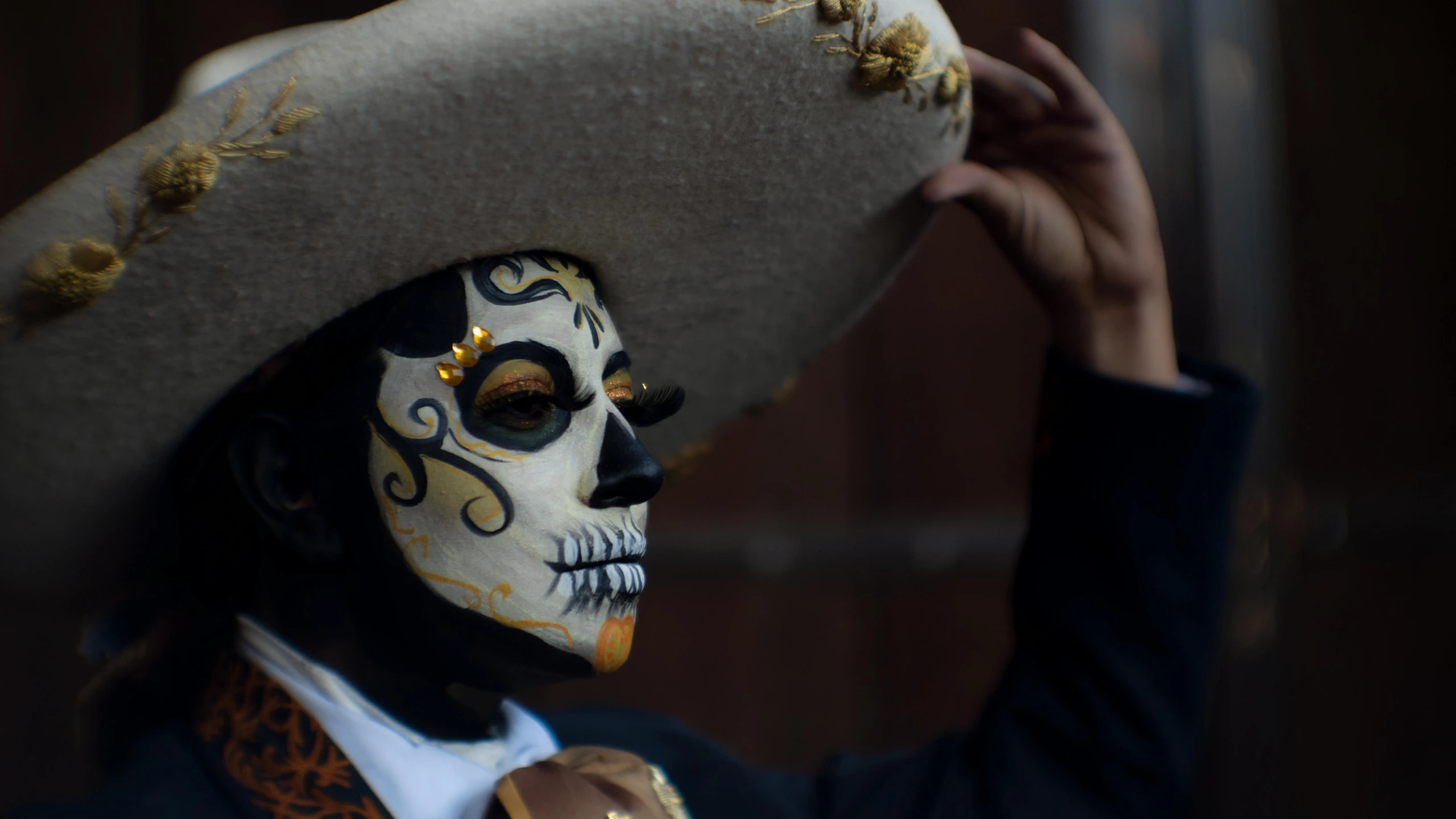 a man wearing a sombrero and hat is standing in the street