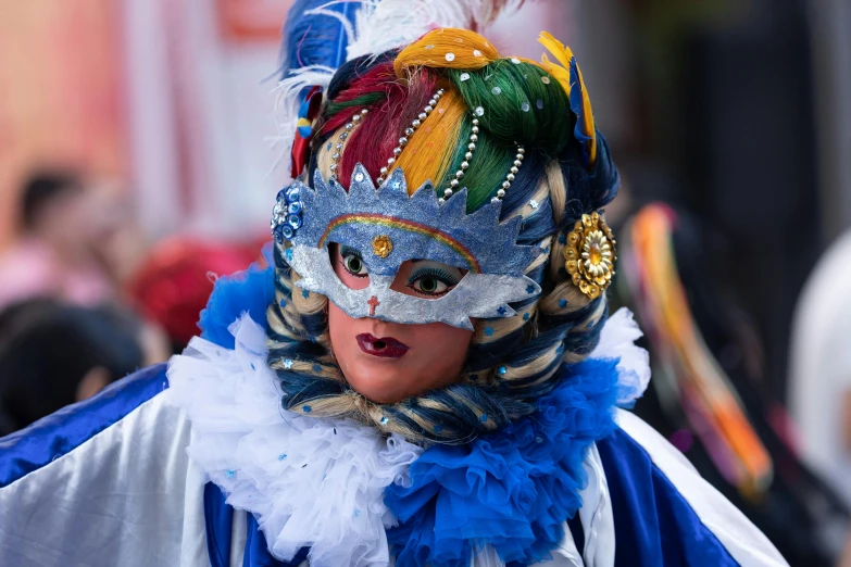 a woman wearing carnival costume and colorful head piece in parade