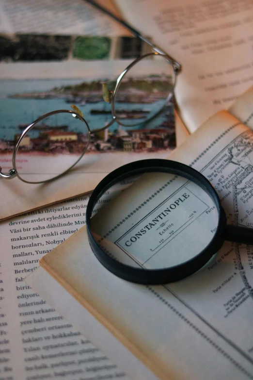 a pair of glasses laying on top of papers