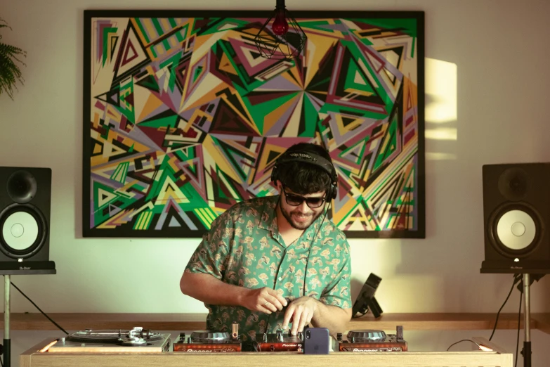 a man in front of a dj mixer working