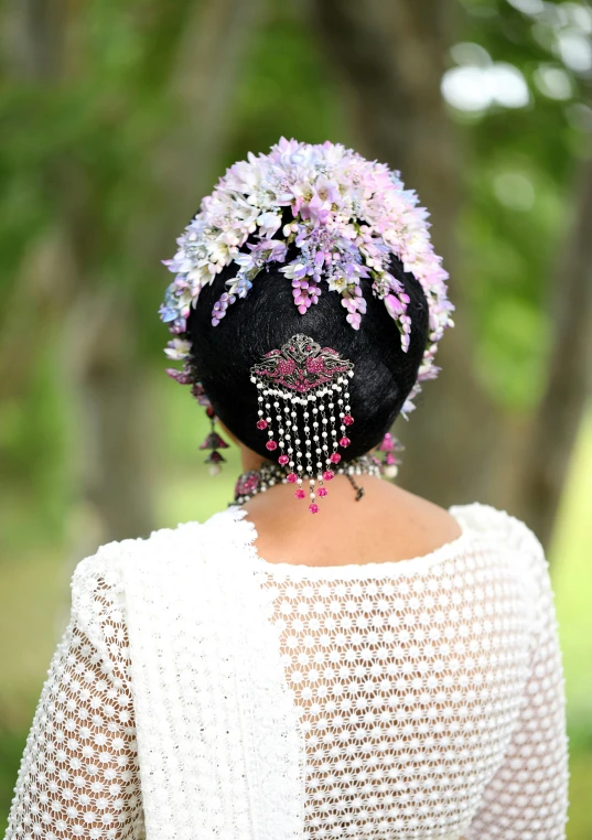 a woman with dark hair with flowers on her head