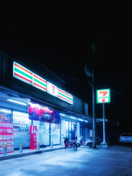 a grocery store is lit up at night