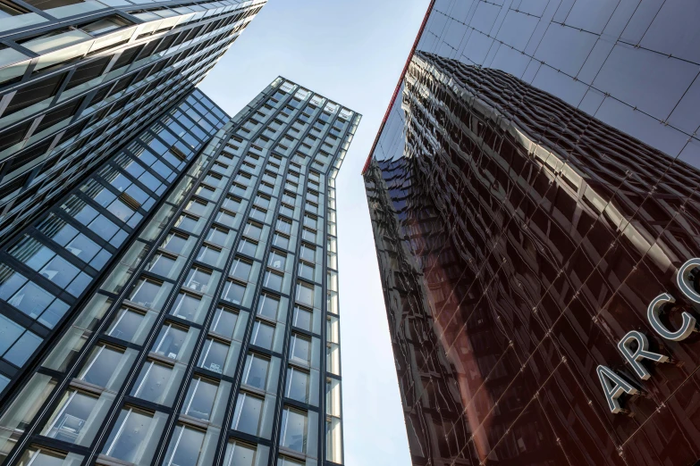 tall buildings stand tall in the sunlight, reflecting against one another