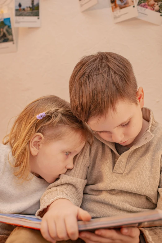 there are two young children laying on a bed