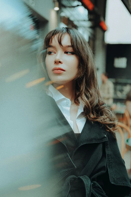 woman in black coat outside on a city sidewalk