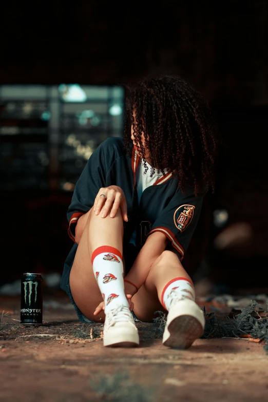 a person with long dreadlocks is sitting by a beer