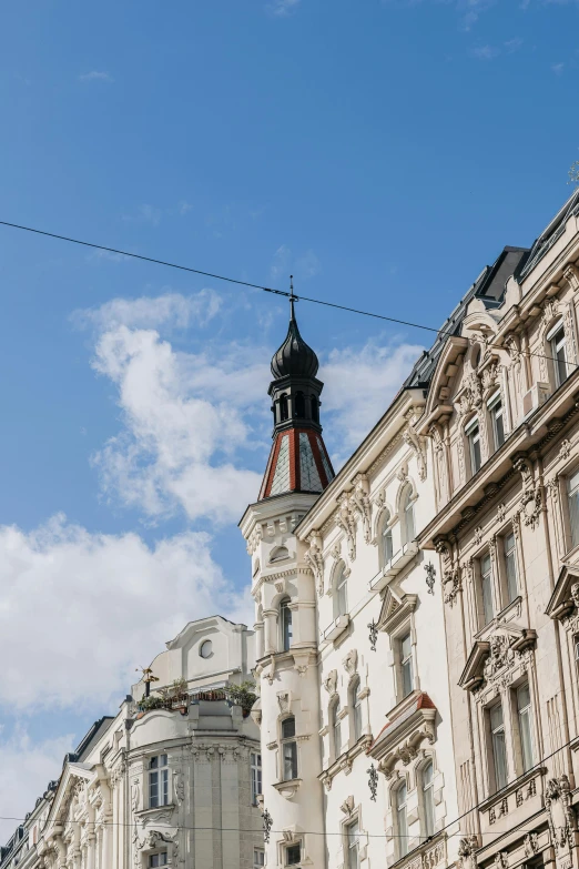 some white buildings are shown in a blue sky